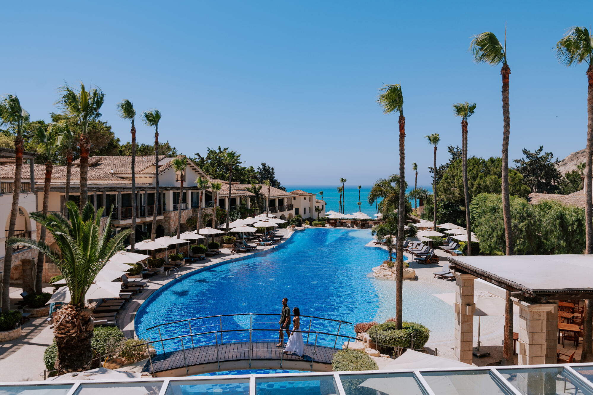 Pool lined with palm trees at Columbia Beach Resort